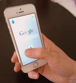 Person holding a phone with Google Search on the screen