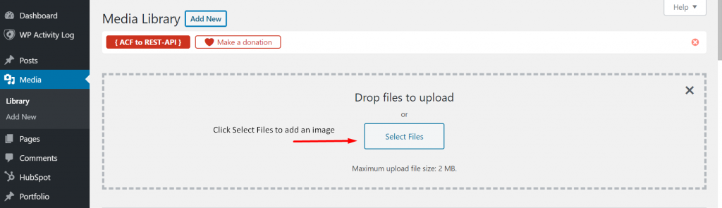 An arrow pointing to "select files" under the media library category in WordPress